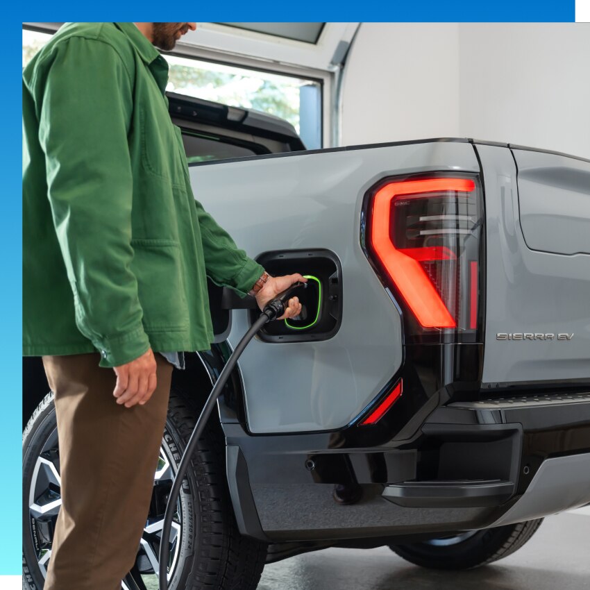 Man charging EV with the GM Energy PowerShift Charger
