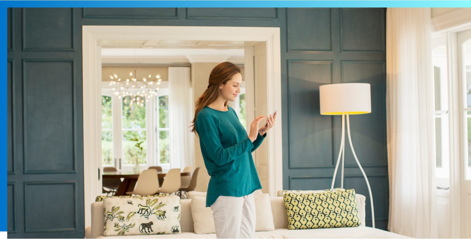 Woman standing in room looking at smartphone