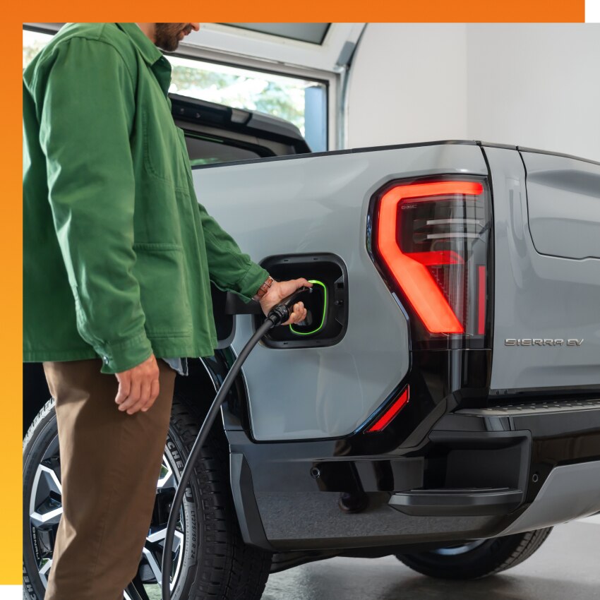 Man charging EV with the GM Energy PowerShift Charger